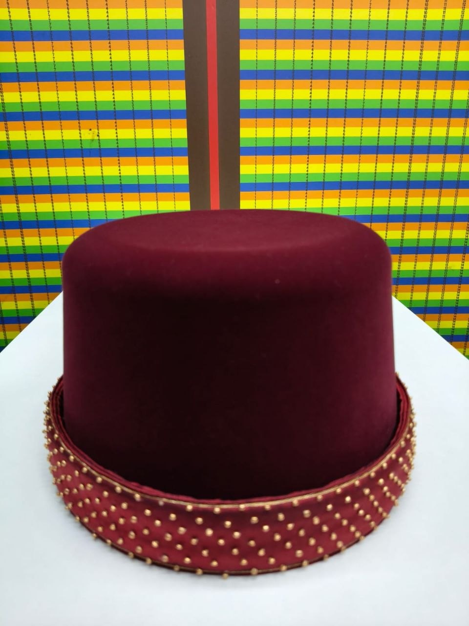 Burgundy cap with gold studded band
